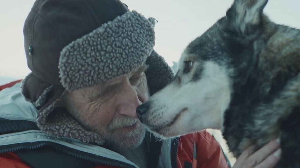 lottery An elderly man touches noses with a husky dog