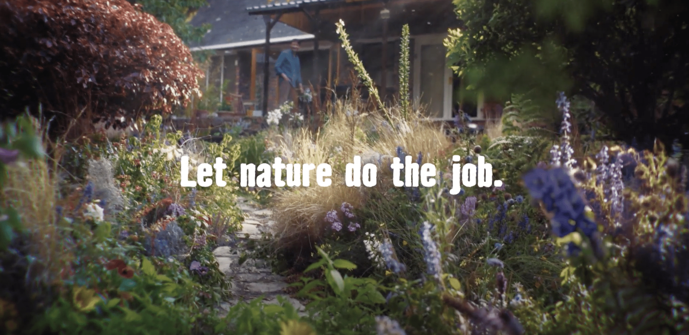 Garden with white text that reads "Let nature do the job"