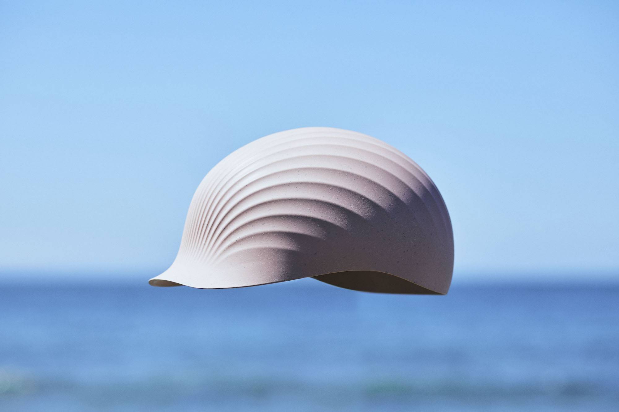 a pink hellmet made of scallop shells