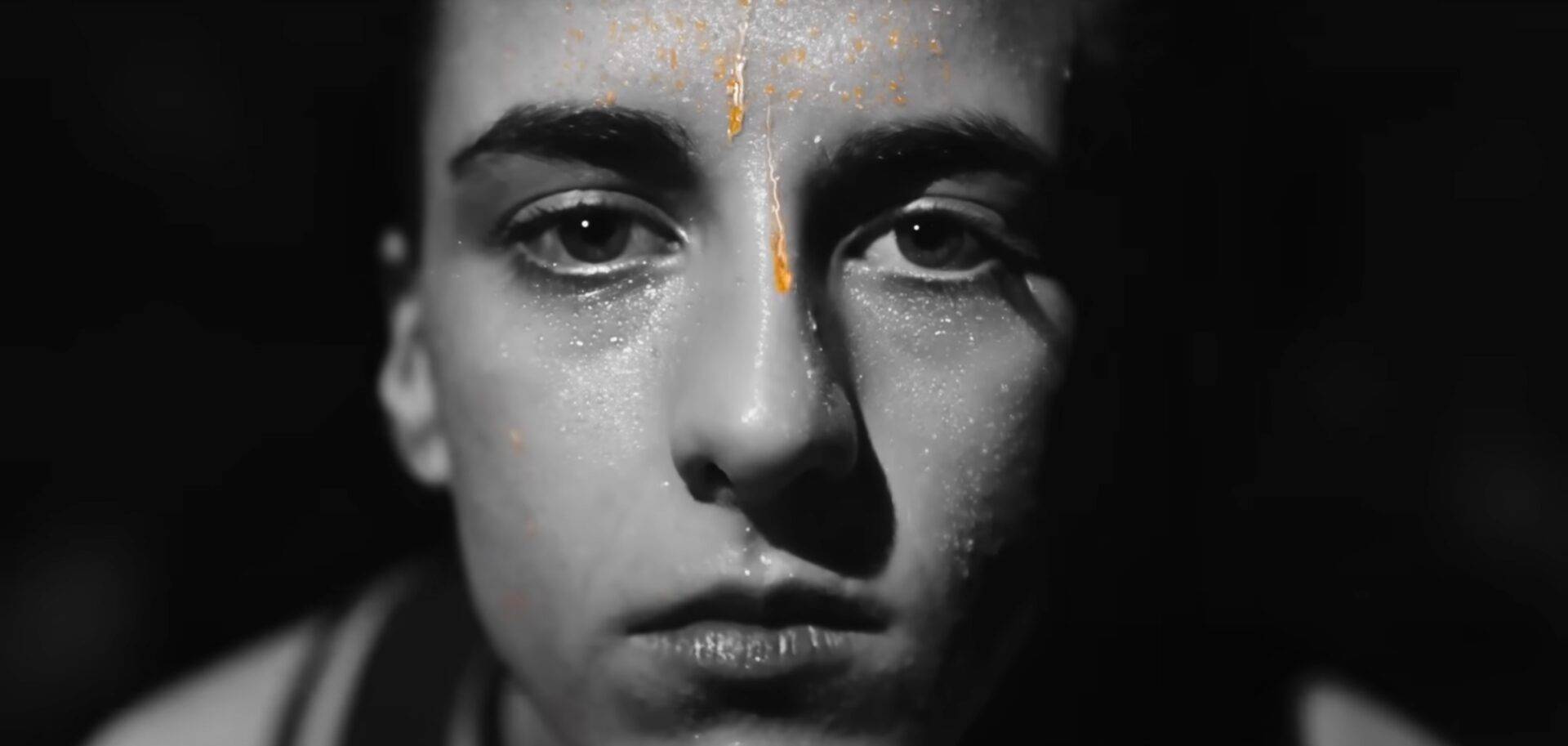 Caitlin Clark in black and white with orange Gatorade sweat