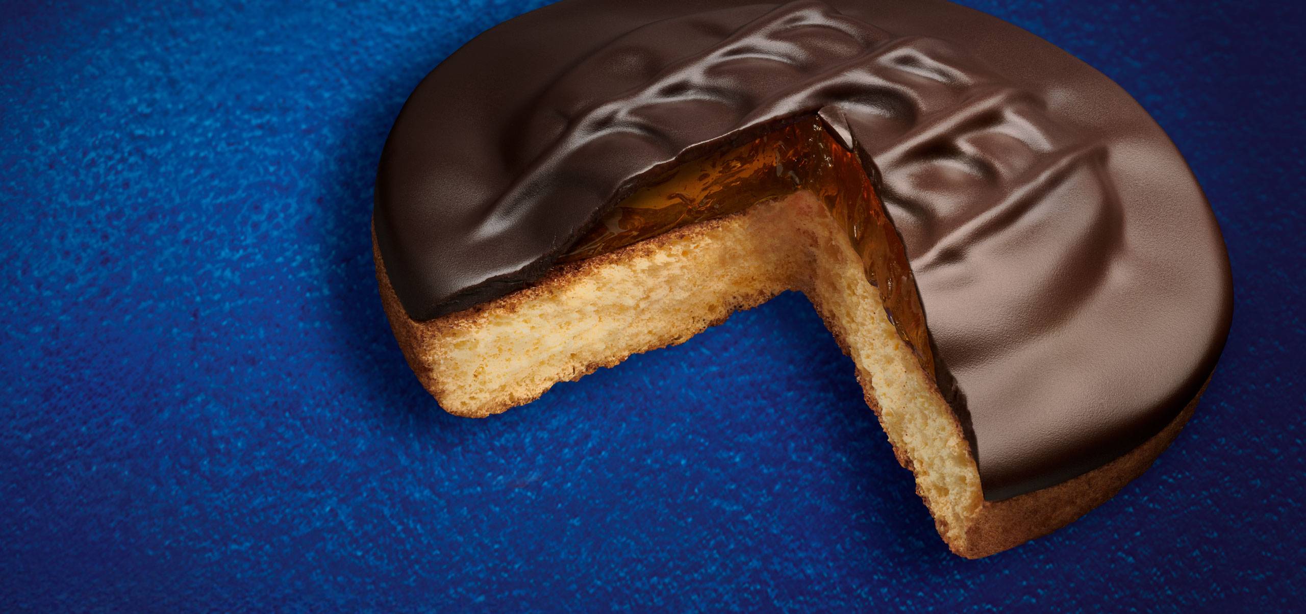 Jaffa_2024_Header Jaffa Cake with a slice taken out of it